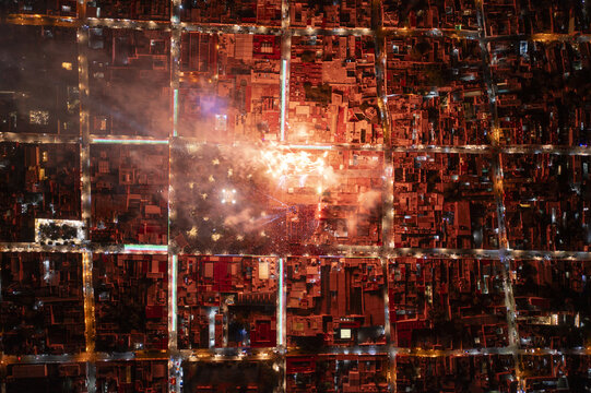 Aerial view of fireworks illuminating the central square of Dolores Hidalgo during a night celebration, with the city grid visible in Dolores Hidalgo, Guanajuato, Mexico.