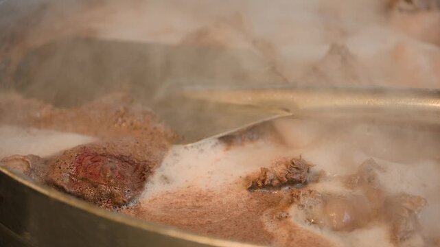 Birria cooking footage showing close up of beef cooking for birria during the traditional Mexican birria cooking process