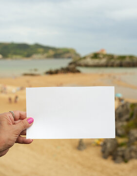 Blank Sign on Beach with Hand and Copy Space