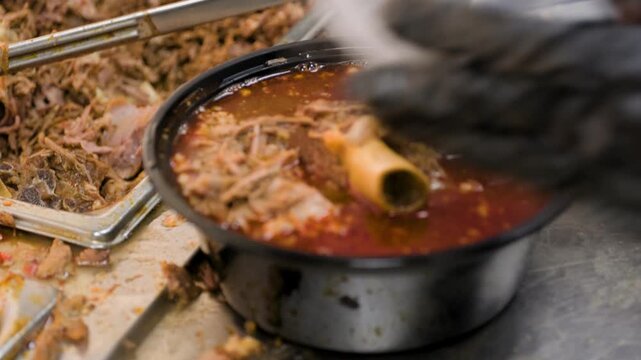 Birria cooking footage showing close up of birria soup to go order during the traditional Mexican birria cooking process