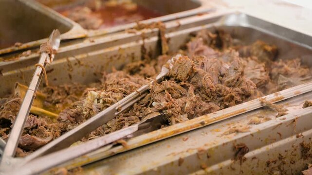 Birria cooking footage showing close up of birria meat in food warmer during the traditional Mexican birria cooking process