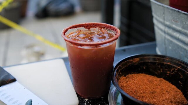 Beverage preparation footage showing michelada drink in drink station during preparation of a savory Mexican michelada drink