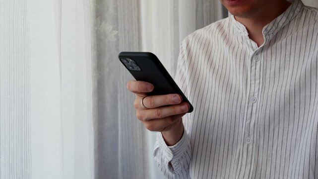 Man using smartphone for online communication and mobile technology.