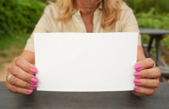 Woman Holding Blank Sign Outdoors with Copy