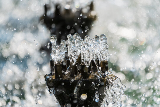 Splashes and jets of water against light background.