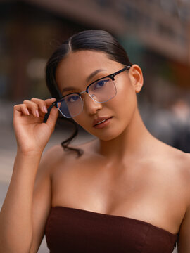 Asian Woman Adjusting Glasses Close-Up Portrait Outdoors