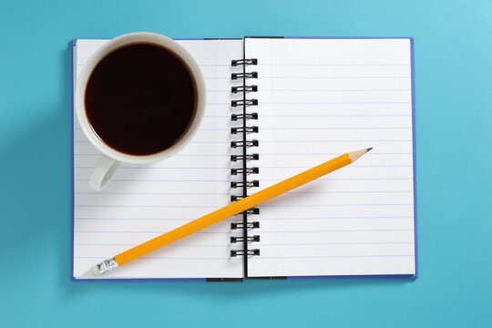 Notebook, Coffee Cup, and Pencil
