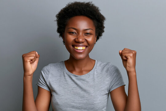 Person celebrating with raised fists and smile