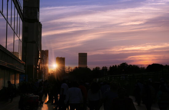 View of Alameda Central at sunset with people walking along the park paths and modern buildings in the background in Ciudad de Mexico, Ciudad de Mexico, Mexico.