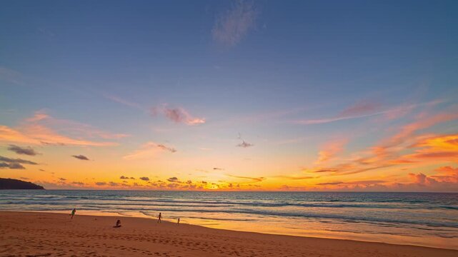 Aerial view of Twilight Serenity at Kata beach Phuket. Soft hues of orange, pink, and violet spread across the evening sky, merging with the calm sea in a breathtaking panorama of tropical beauty.