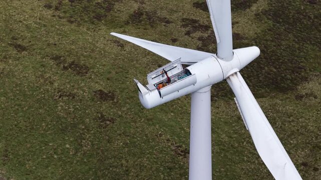 Aerial view of wind turbine maintenance technician working inside nacelle