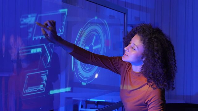 Businesswoman using a futuristic digital interface in a modern workspace, representing AI, data analytics, digital transformation, cybersecurity, innovation, and business technology.