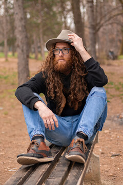Hippie Man Drawing On Checkered Surface While Meditating Outdoors