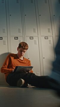 Teen Sitting on Floor Near Lockers, Working on Graphic Illustration During Break. Gen Z Youth Lifestyle, Self Development, Choosing Creative Future Career Path in Visual Arts, Design. Vertical Shot.
