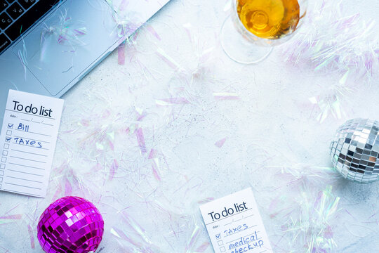 Top view of laptop with confetti and disco ball. Admin night party - work with fun concept