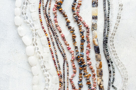 Jewelry and precious concept. Gemstones and beads for necklace, top view, flat lay
