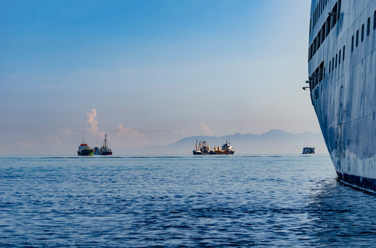 View into land of Assorted Tankers and ships sailing in ocean, Indonesia