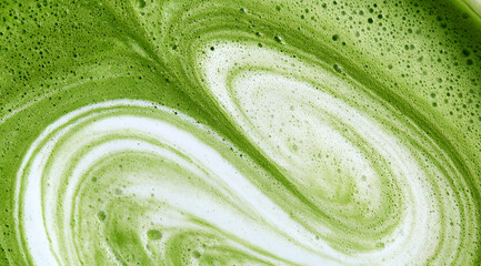 Naklejka na ściany i meble a frothy matcha latte, known for its distinctive emerald hue and subtle swirls of creamy foam, captured in both macro and wide-angle shots, featuring a detailed texture close-up and viewed from the to