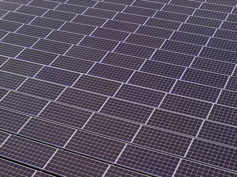 Aerial view of a large array of solar panels installed on an industrial roof, showcasing clean energy technology in Derby, CT, United States.