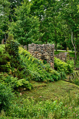 Naklejka premium Ancient Stone Ruins in a Lush Green Forest Landscape
