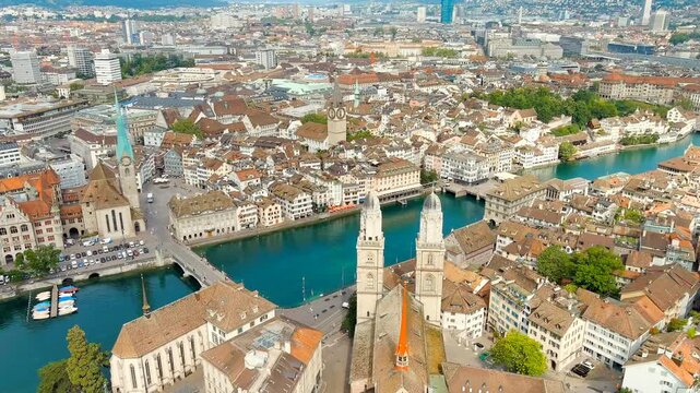 Zurich, Switzerland. Grossmunster, Romanesque twin towers with domed helmets, aerial panoramic view over the Limmat River and Old Town on a bright summer day. Drone footage, Point of interest