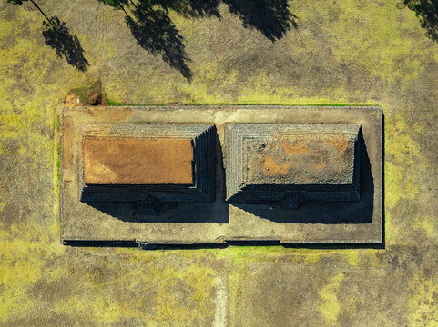 Aerial view of the ancient stone pyramids at Zona Arqueologica de Ihuatzio surrounded by dry grassy terrain in Ihuatzio, Michoacan, Mexico.