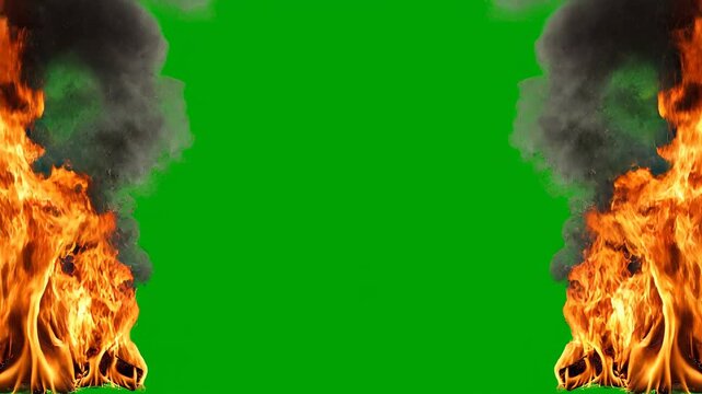 Fiery explosion with dark smoke against a vibrant green screen background during a cinematic motion sequence