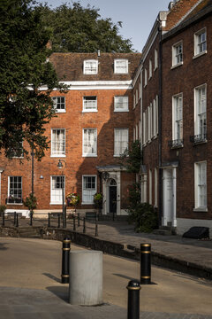 View of historic red brick buildings with sash windows and a street corner in Worcester, England, United Kingdom.