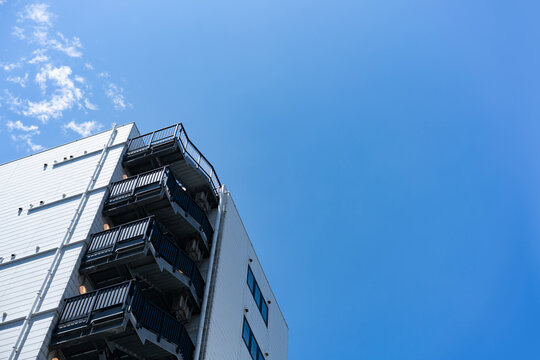 Fire Escape Stairs on Modern Apartment Building Facade for Real Estate Property Management and Building Safety Concept, Low Angle Perspective Photo with Copyspace