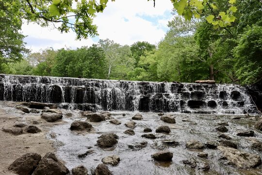 The flowing waterfall in the park.
