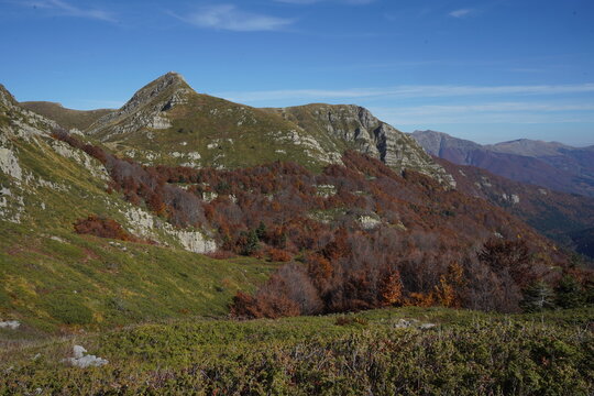 View of Lago Nero surrounded by autumn foliage on the mountain slopes in Abetone Cutigliano, Tuscany, Italy.