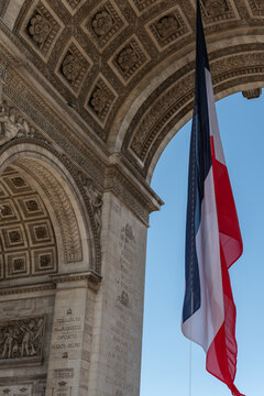 Paris, France: Arc de Triomphe in Paris with a big French flag under it