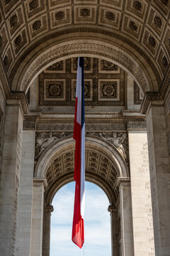 Paris, France: Arc de Triomphe in Paris with a big French flag under it