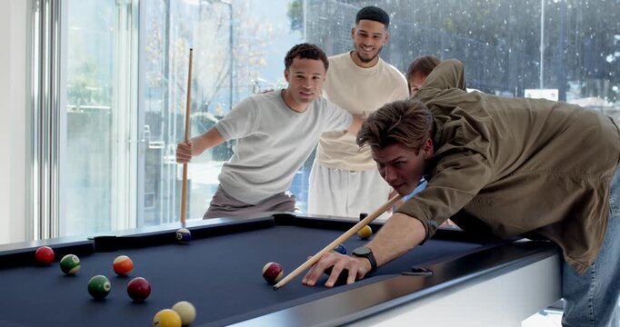 Diverse male friends watching shooter pulling cue, hitting balls on pool table for fun, copy space