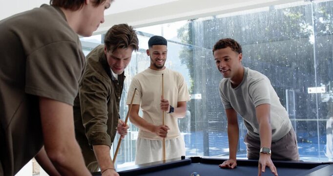 Diverse male friends gathering to play pool at home, racking balls, holding cues on blue-felt table
