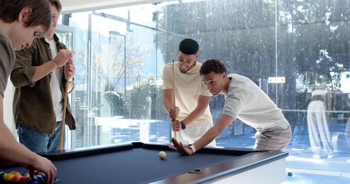 Diverse male friends positioning cue ball, urging friend racking balls at pool table starting game