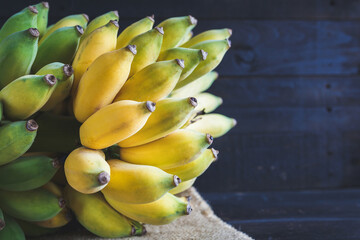 Fresh bananas on the dark background © Thai