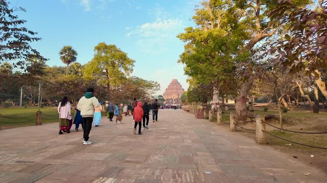 Eye-Level Wide Angle Of Tourists In Winter Clothing Walking Towards 13th-Century Konark Sun Temple