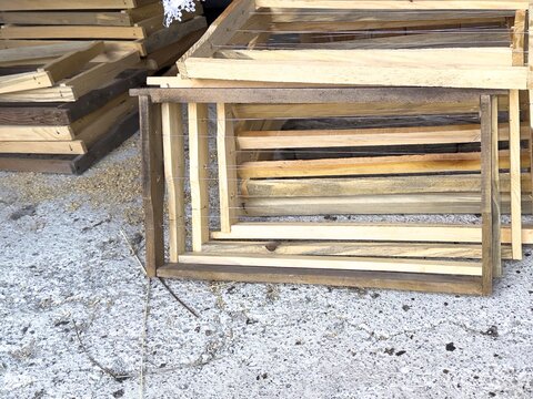 View of wooden beehive frames stacked on a concrete surface in Posof, Ardahan, Turkiye.