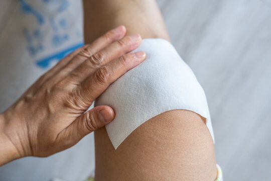 Apply a medicated patch to the knee.