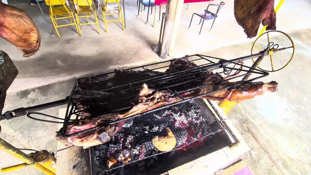 Slow roasting a whole animal on a metal spit over hot glowing coals. Traditional outdoor rotisserie barbecue cooking with crispy skin turning.