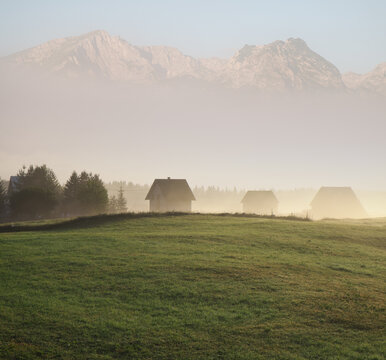 dreamy landscape with village and mountains peaks over the morning fog in Montenegro