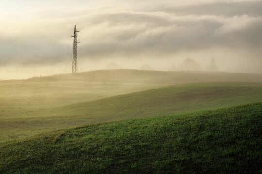 dreamy scene with morning fog and pylon of electricity in Montenegro