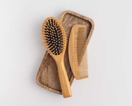Eco friendly wooden hair brush and comb set on wooden tray