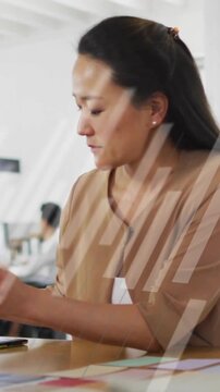 Animation of financial data processing over asian businesswoman in office