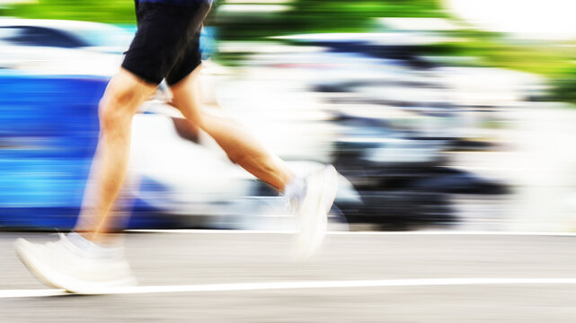 Runner in motion with intentional motion blur during an outdoor run