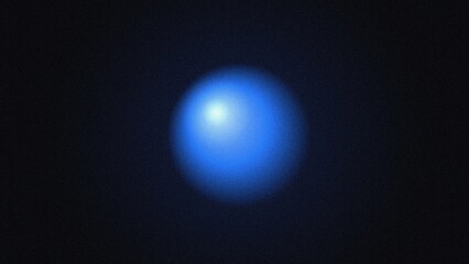 Obraz premium Glowing blue sphere with grainy texture isolated on a dark black background, abstract orb shape