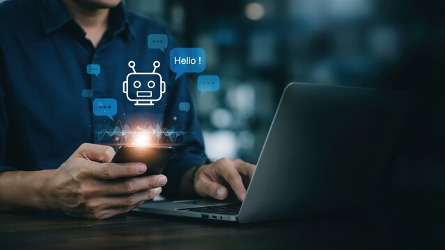 Professional using smartphone with chatbot interface and laptop