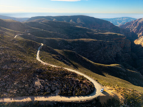 Aerial view of mountain pass with dirt road
