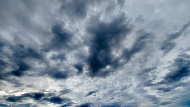 Dramatic tropical storm clouds fill the sky. Heavy clouds create a moody atmosphere across the sky.